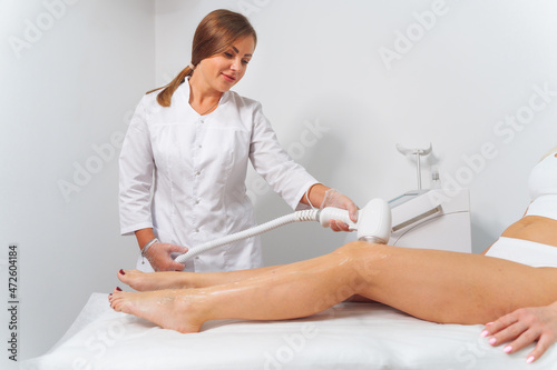 Laser epilation and cosmetology in beauty salon. Laser hair removal, skin care. Master dolaser hair remove prosedure.