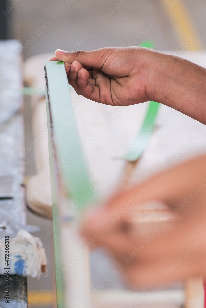 Obraz premium Young carpenters installing laminate for built-in cabinets at the workshop