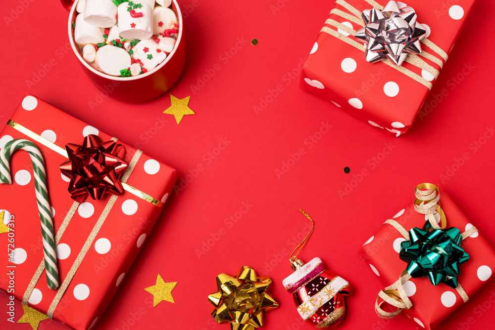 Christmas background Christmas present box cup of chocolate with marshmallow and decorations on red background Top view with copy space Horizontal Christmas background Christmas present box cup of chocolate with marshmallow and decorations on red background Top view with copy space Horizontal