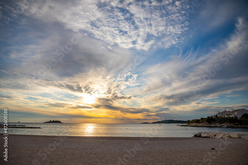 Beautiful area Lozica of Rogoznica town with sandy beach  white architecture and fishing boats at sunset time  Croatia.