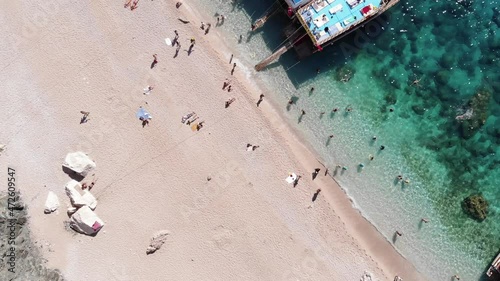 Top view of tourists on a white beach and a bay with yachts in the clear turquoise waters of the Mediterranean near the island of Suluada photo