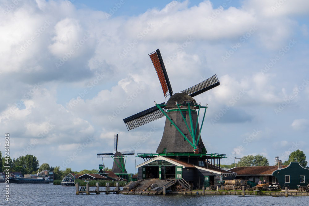 Historic windmills and the river Zaan in Zaandam. The Zaanse Schans is an area known for its historic and well-preserved windmills and houses.