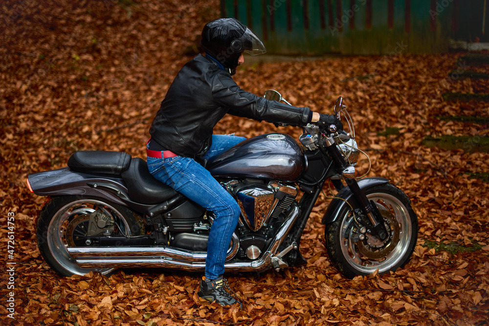 Handsome biker in the forest in autumn. Handsome biker in the forest in autumn.