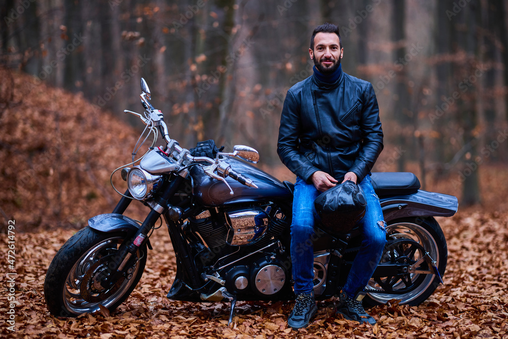 Handsome biker in the forest in autumn. Handsome biker in the forest in autumn.