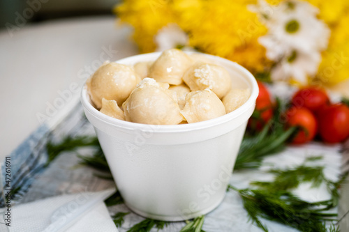 Cooked dumplings with cheese in a deep bowl