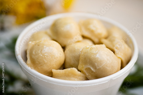 Cooked dumplings with cheese in a deep bowl