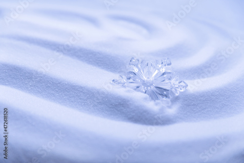 Decorative snowflakes on white snow. Winter holidays background