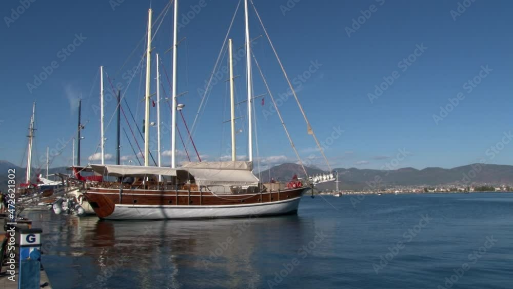 Marmaris, Turkey - September 12, 2010: Luxe yachts quietly stand on background of blue sky in harbor of Mediterranean Sea. Marmaris, Turkey - September 12, 2010: Luxe yachts quietly stand on background of blue sky in harbor of Mediterranean Sea.
