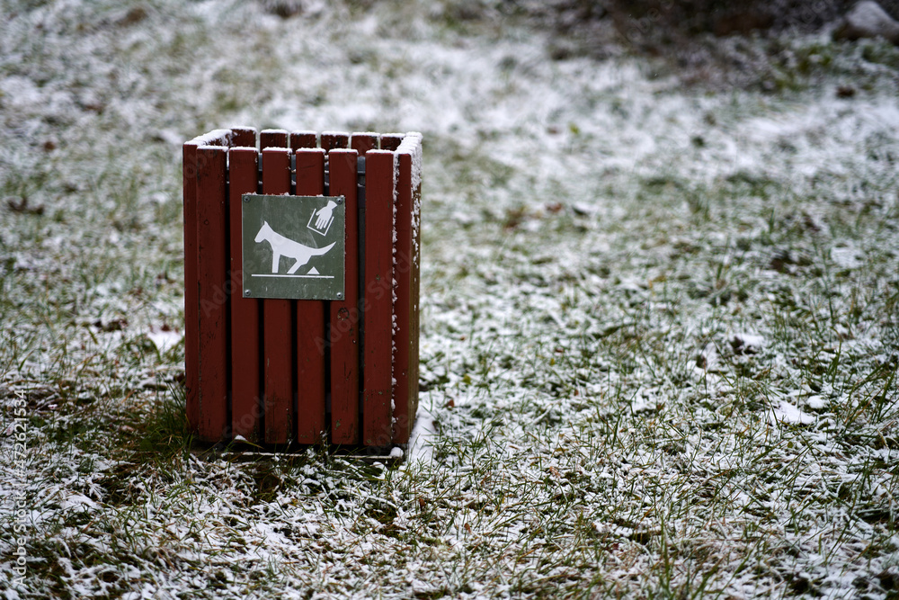 Red dog waste container. Public trash can for dog waste poop sign