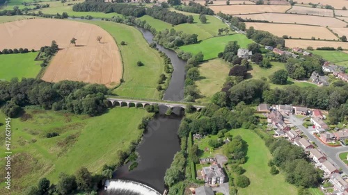 Aerial footage of the the historic Tadcaster abandoned railway viaduct and River Wharfe locate in the West Yorkshire British town of Tadcaster in Leeds, taken on a bright sunny summers day photo