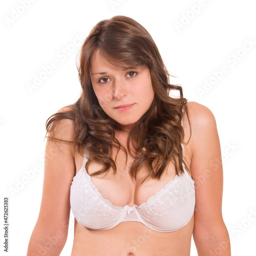 Closeup portrait of a beautiful young woman wearing a white bra, isolated on white background
