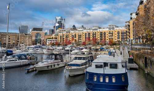  Luxury residential buildings and vintage sailing ships moored at St Katherine Dock, London.  photo