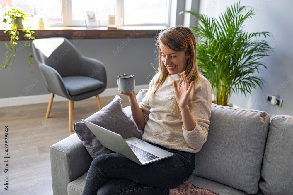 Cropped shot of an attractive young businesswoman sitting and vlogging on her laptop while enjoying a cup of coffee. Attractive young woman using her laptop to make a video call at home Cropped shot of an attractive young businesswoman sitting and vlogging on her laptop while enjoying a cup of coffee. Attractive young woman using her laptop to make a video call at home
