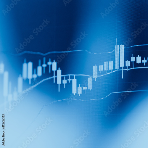Abstract financial trading graphs and digital number of foreign exchange market trading on monitor. Background of gold and blue digital chart to represent stock market trend. 