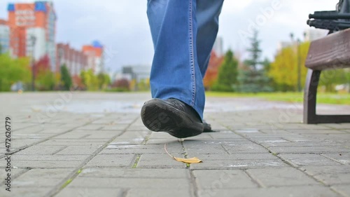 The pedestrian's shoe laces were untied and he sat down on a bench to tie them