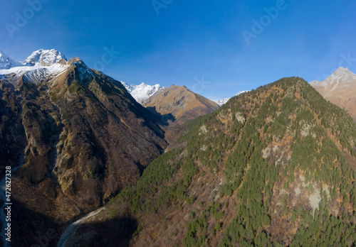 Scenic autumn mountain landscape with snow peaks, Tuymazinsky glacier, Digor Gorge, Northern Ossetia, Caucasus, Russia