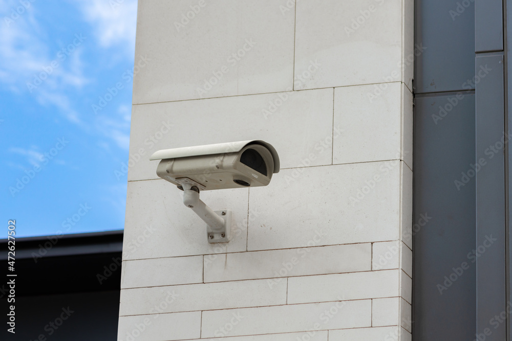 Surveillance camera built into the stone wall of the building Surveillance camera built into the stone wall of the building