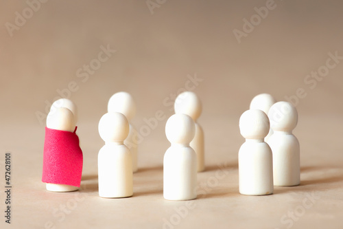 Eight wooden humans stand in a circle.