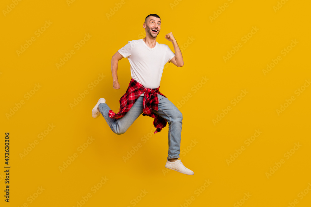 Full length body size photo man jumping up running on shopping sale isolated vivid yellow color background