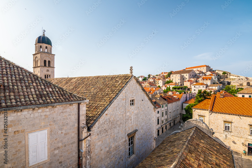 Aerial panoramic view of old city of Dubrovnik. Church tower and look to ancient buildings. Sunny day.