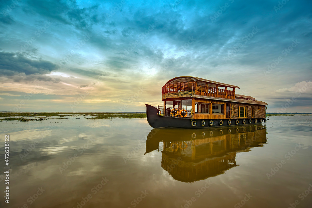 Travel tourism Kerala background - houseboat on Kumarakom backwaters,India. Kerala houseboat image Stock Photo | Adobe Stock