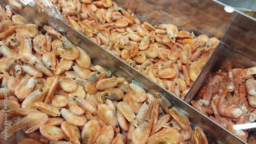 Selling frozen large shrimp in a store on a showcase. Healthy seafood Selling frozen large shrimp in a store on a showcase. Healthy seafood