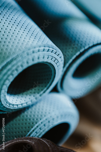 Rolled-up yoga mats abstract background