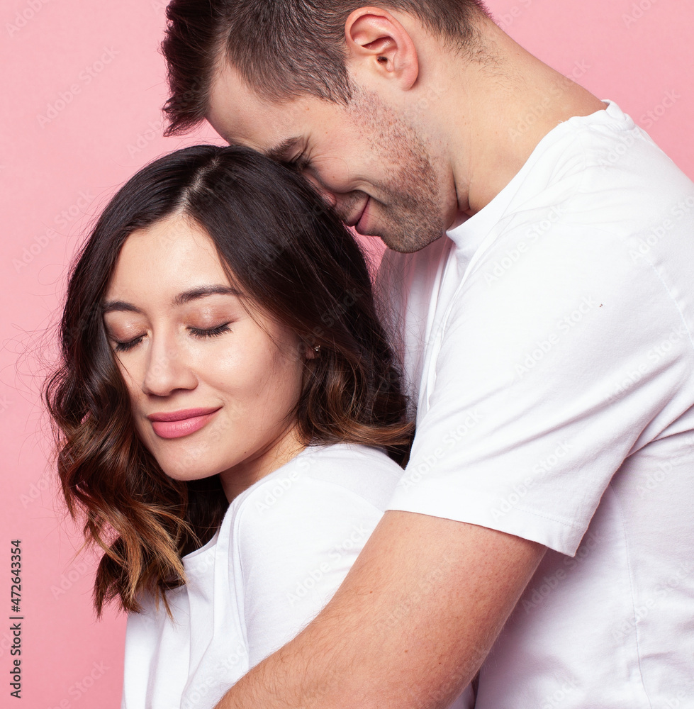 young cheerful caucasian couple together having fun on pink background, guy ang girl modern relationship, lifestyle people concept young cheerful caucasian couple together having fun on pink background, guy ang girl modern relationship, lifestyle people concept