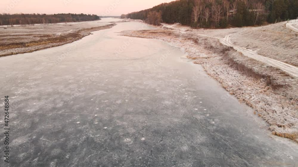 Field, forest and river under the snow in the orange light of the sun. In winter, at sunset, in the evening. Screensaver, footage, nature for intro, background, titles. UHD 4K. Field, forest and river under the snow in the orange light of the sun. In winter, at sunset, in the evening. Screensaver, footage, nature for intro, background, titles. UHD 4K.