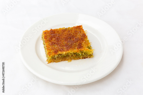 traditional dessert kadayif with pistachio on white background