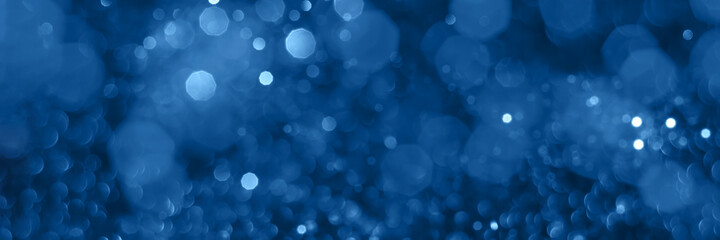 Blue sparkling glitter bokeh background, christmas texture. Holiday lights. Abstract defocused header. Wide screen wallpaper. Panoramic web banner with copy space for design