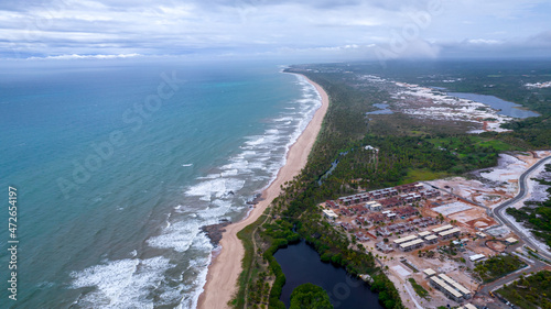 Aerial view of Imbassai beach, Bahia, Brazil. Beautiful beach in the northeast with a river and palm trees. photo