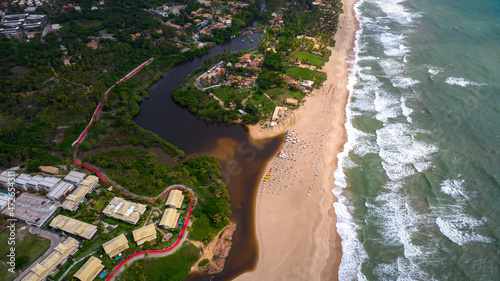 Aerial view of Imbassai beach, Bahia, Brazil. Beautiful beach in the northeast with a river and palm trees. photo