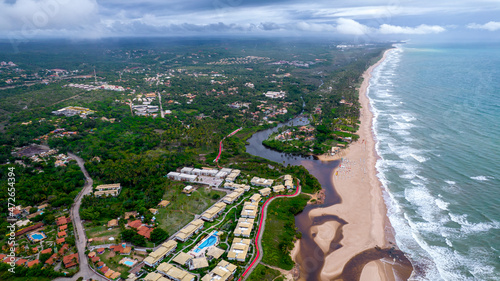 Aerial view of Imbassai beach, Bahia, Brazil. Beautiful beach in the northeast with a river and palm trees. photo