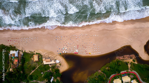 Aerial view of Imbassai beach, Bahia, Brazil. Beautiful beach in the northeast with a river and palm trees. photo