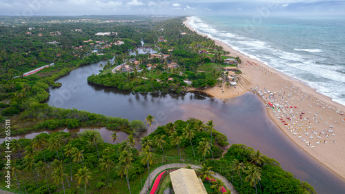 Aerial view of Imbassai beach, Bahia, Brazil. Beautiful beach in the northeast with a river and palm trees. photo