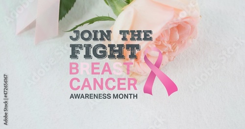 Composition of breast cancer ribbon with awareness slogan over rose on white table, copy space