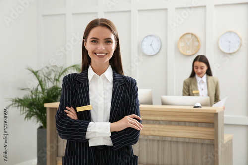 Obraz na plátně Portrait of beautiful receptionist near counter in hotel