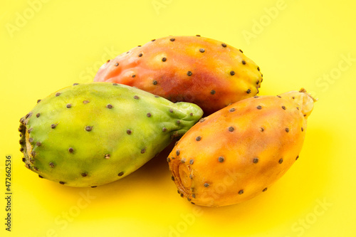 close up of Opuntia ficus indica, exotic fruits on yellow background
