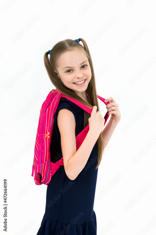Happy cute child girl in school uniform. Schoolgirl with facial expression isolated on white. Concept of education, reading, back to school Happy cute child girl in school uniform. Schoolgirl with facial expression isolated on white. Concept of education, reading, back to school