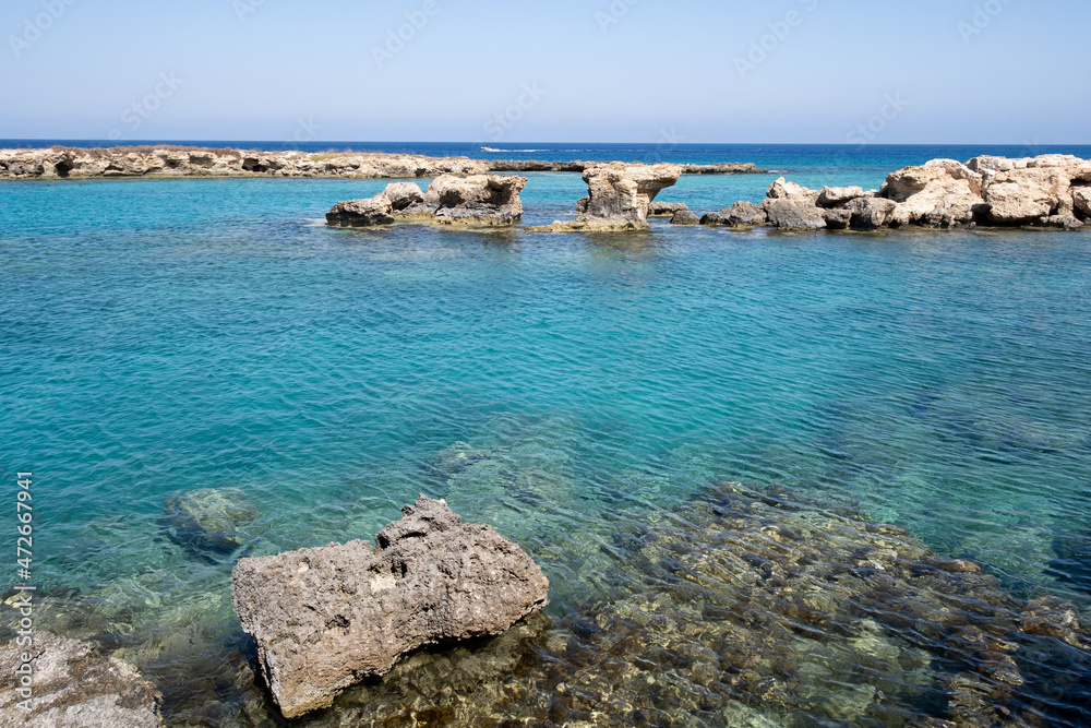 Rocky coastline with turquoise blue calm clean water and sky. Mediterranean sea Cyprus