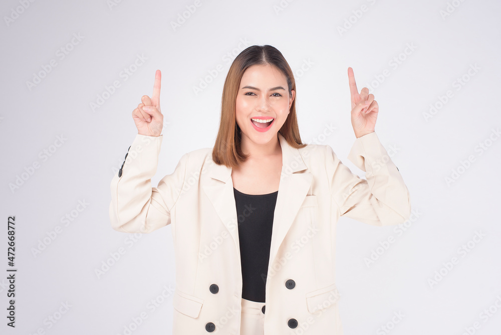 Portrait of young beautiful businesswoman wearing suit in white background studio.. Portrait of young beautiful businesswoman wearing suit in white background studio..