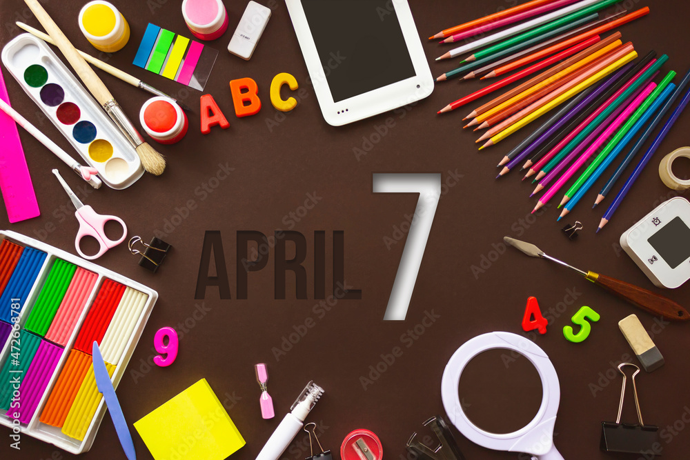 April 7th. Day 7 of month, Calendar date. School notebook and various stationery with calendar day. School and office supplies frame. Spring month, day of the year concept. April 7th. Day 7 of month, Calendar date. School notebook and various stationery with calendar day. School and office supplies frame. Spring month, day of the year concept.