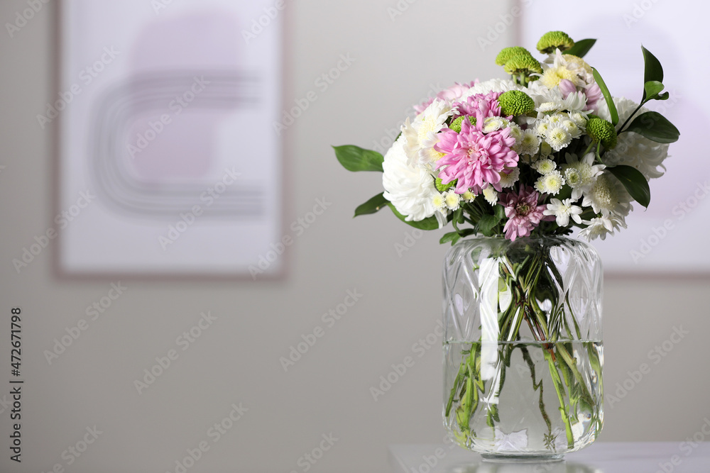 Bouquet of beautiful chrysanthemum flowers on table in room, space for text Bouquet of beautiful chrysanthemum flowers on table in room, space for text