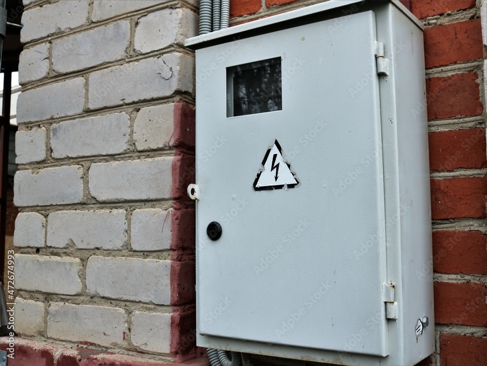 old metal box with electrical wires and energy consumption sensors