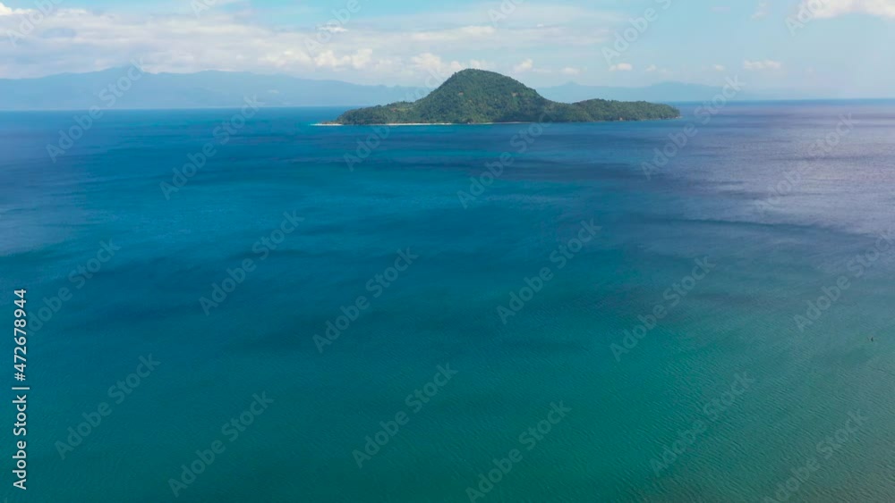 Island with a white beach, top view. Atulayan Island, Camarines Sur, Philippines.Sea landscape, blue sea and tropical island with a jungle. Summer and travel vacation concept. Island with a white beach, top view. Atulayan Island, Camarines Sur, Philippines.Sea landscape, blue sea and tropical island with a jungle. Summer and travel vacation concept.