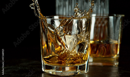 Freeze motion of falling ice cube into whisky