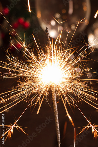 New Year celebration. Bright sparkler on festive night.