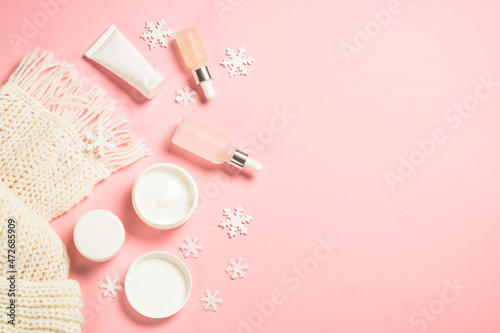 Winter skin care product. Winter cosmetic at pink background. Flat lay with copy space.