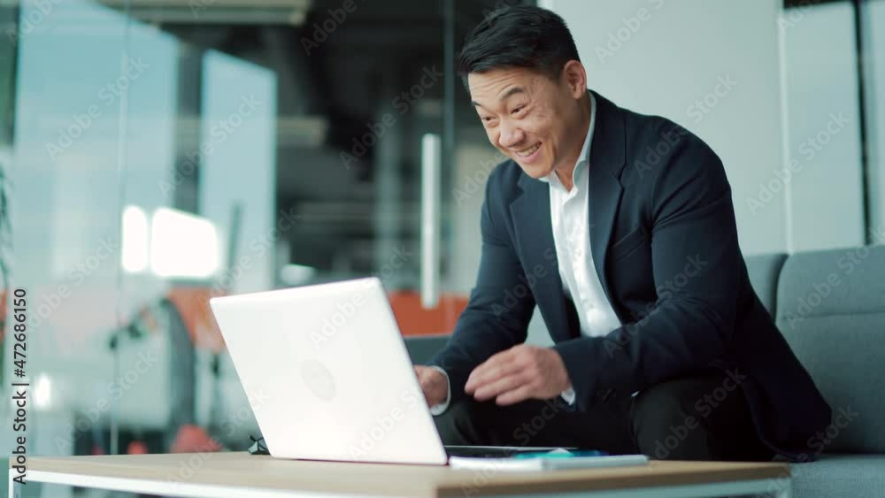 Amazed asian male professional winner feeling happy receiving new job opportunity, reward bonus, celebrates financial market growth. Excited business man checking email reading great news on laptop Amazed asian male professional winner feeling happy receiving new job opportunity, reward bonus, celebrates financial market growth. Excited business man checking email reading great news on laptop